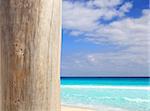 Caribbean tropical beach wood weathered pole on sea foreground