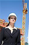 Woman on job site with crane in background