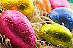 Colorful easter eggs in straw - close up with shallow depth of field