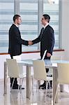two young businessman handshake on business meeting at modern office and representing success