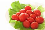 Fresh rosa tomatoes and butter lettuce on white plate
