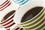 Close ups of mugs of black coffee