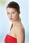 Attractive young nude woman covering her self with red towel, getting ready for spa treatment, isolated on white