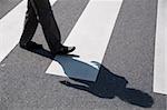 Female crossing the street using a zebra crossing and posing great shadows