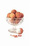 lychees in glass vase isolated on white background