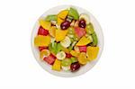 Tropical fruit salad on white plate on white background photographed from above (Isolated)