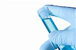 Hand in a glove holding a test tube with blue liquid on a white background.