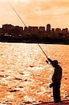 Lone fisherman during late hours of sunset