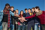 Happy College Students with Hands on Stack