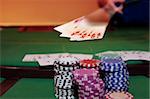royal flush has poker player showing winning hand of cards with the chips in the foreground