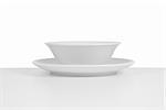 White ceramic bowl and dish on white background.