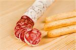 Spanish fuet salami chopped on  wooden board