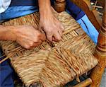 enea traditional spain dried reed chair handcraft man hands working seat