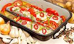 Tasty roasted fish with vegetables in pan