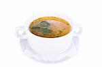 Vegetable soup in a white cup on a white background