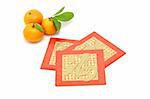 Chinese New Year mandarin oranges and red packets on white background