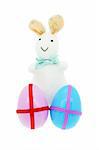 Toy bunny with decorated Easter eggs on white