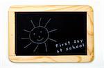a chalkboard with a sun and the note for the first day at school