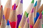 Close-up of the tips of colored pencils on a white background