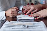 Beautician applies nail polish in spa salon