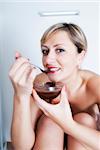 Woman playing with chocolate before massage in spa salon