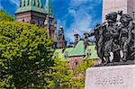 The National War Memorial in Ottawa, Canada with Parliament Hill in the background.