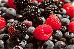 Mixed raspberries, blueberries and blackberries background