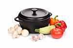 old black cast-iron cauldron with vegetables isolated on white