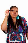 Young beautiful black woman applying mascara, isolated on white background