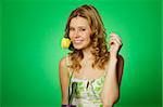 HappyClose up on a green background Happy young woman hugging a yellow tulip. Young Woman Hugging Flower