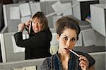 Female office worker thinks while her colleague threatens to stab her with a Samurai sword