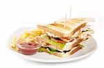 club sandwich with fries and sauce on white plate isolated on white background
