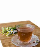 chamomile tea on wooden mat with fresh herbs