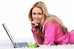 Young and beautiful girl lying at carpet with laptop