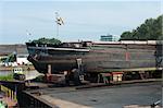 man repairing the body of a ship in a dry-dock