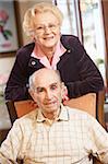 Senior couple relaxing in armchairs