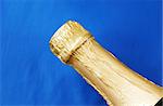 Close up view of a champagne bottle isolated on blue