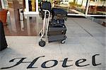 Suitcases and trolley in front of hotel