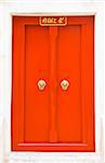 The red wooden door of Thai temple with Chinese knock door style