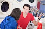 Two young men argue in the laundromat