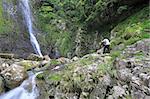 waterfall and a man taking photo