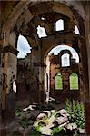 Interior of the red church showing archways, pillars and dilapidation. Dates to the 6th century now in ruins, portrait with crop space