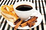 cookies, coffee and cinnamon on a striped tablecloth