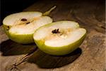 autumn fresh pears cut  in half over old wood board