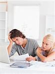 Unhappy couple doing paperwork in their living room