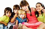 Group of five little kids sitting smiling and hugging, isolated on white