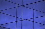Glass building abstract exterior. Modern architecture facade blue lines background.