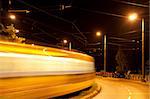 Night view of a main road with blurry movement of a tram