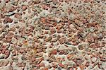 Detail of multicolor stone wall with granite colored stones