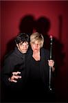 Scary pagan couple in black with sceptre